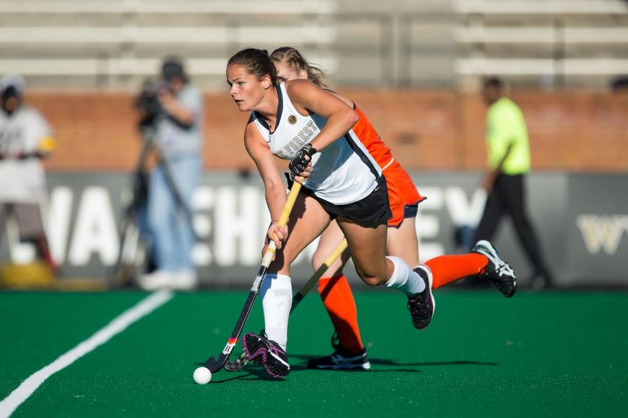 Nicola Pluta (34) of the Wake Forest Demon Deacons pushes the ball up the field during first half action against the Virginia Cavaliers in semi-final action at the 2016 ACC Field Hockey Championship at Kentner Stadium on November 4, 2016 in Winston-Salem, North Carolina.  The Cavaliers defeated the Demon Deacons 3-2 in overtime.  (Brian Westerholt/Sports On Film)