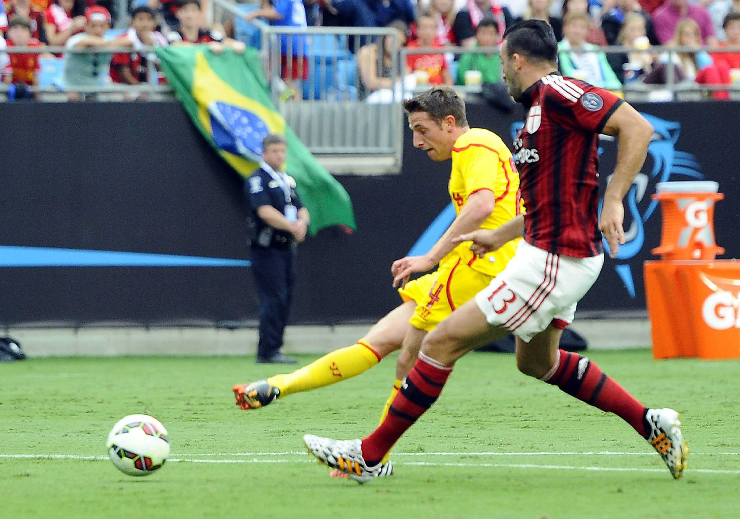 Liverpools Joe Allen shoots past AC Milans Adil Rami (13) in the first half during International Champions Cup semifinals at Bank of America Stadium in Charlotte, N.C., on Saturday, Aug. 2, 2014. Liverpool won, 2-0. (David T. Foster, III/Charlotte Observer/MCT)