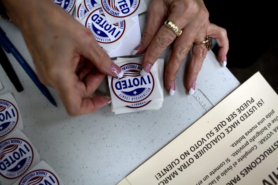 A poll worker gets I Voted stickers ready to hand to voters as they finished up at the ballot booths. (Carolina Hidalgo/Tampa Bay Times/TNS)