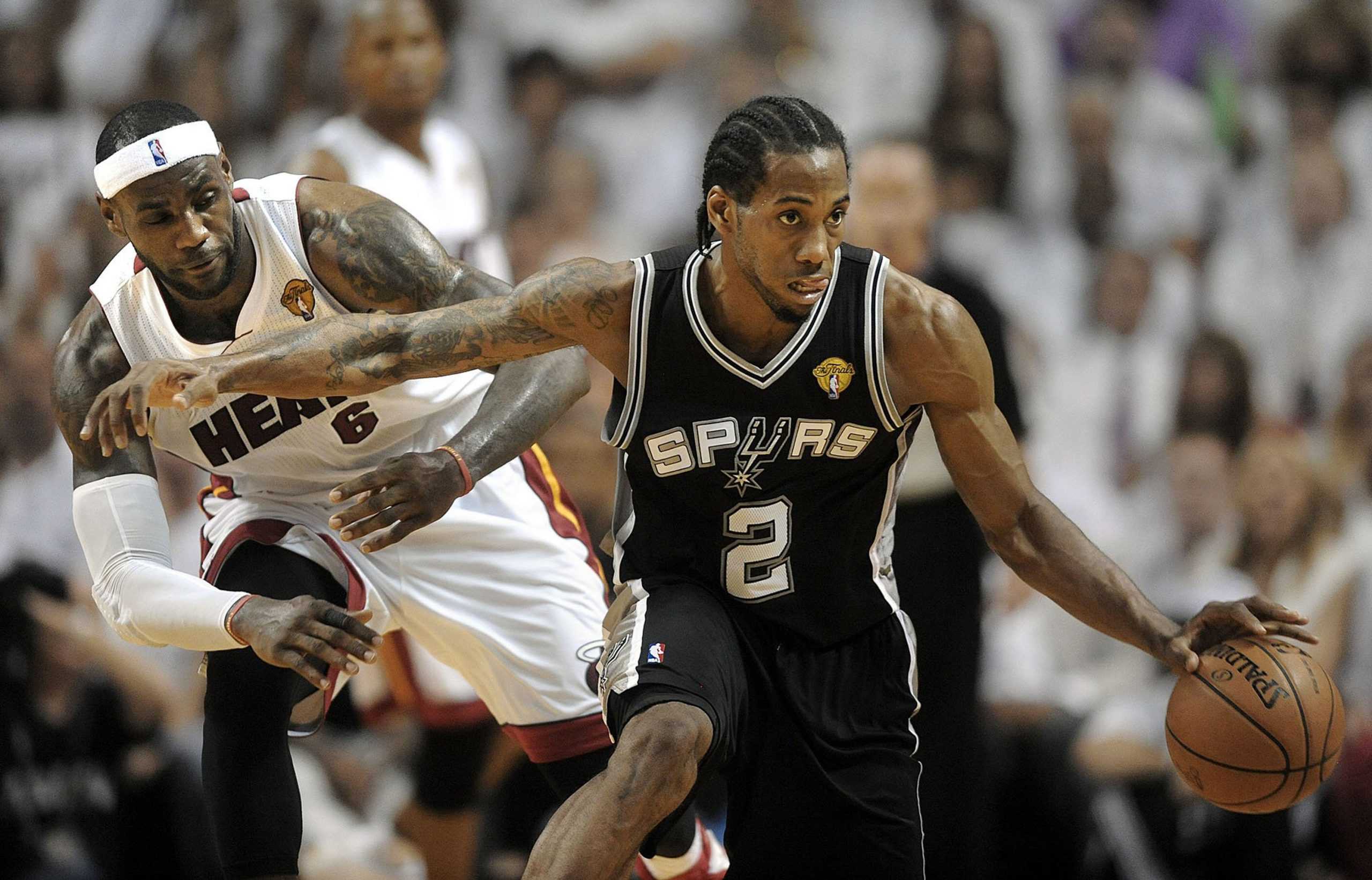 The San Antonio Spurs Kawhi Leonard (2) dribbles around the Miami Heats LeBron James during Game 4 of the NBA Finals at American Airlines Arena in Miami on June 12, 2014. (Michael Laughlin/Sun Sentinel/TNS)