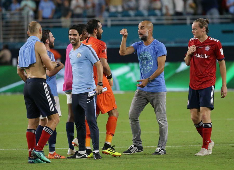 Manchester City head coach Josep Guardiola celebrates with goalkeeper Claudio Bravo and other players after a 3-0 victory against the Bayern Munich in an International Champions Cup match at Hard Rock Stadium in Miami Gardens, Fla., on Saturday, July 28, 2018. (Pedro Portal/Miami Herald/TNS)