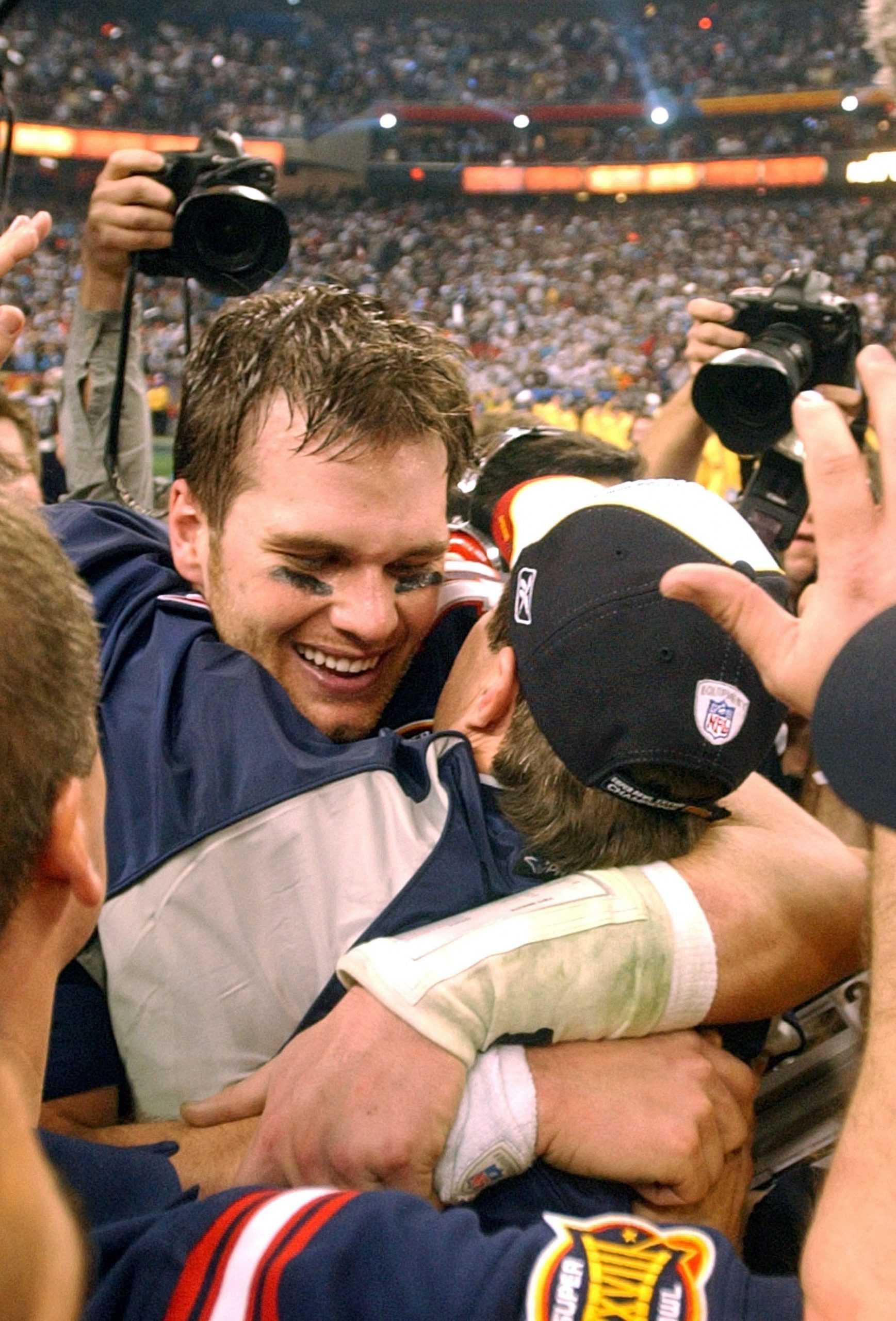 New England quarterbac Tom Brady receives a hug from head coach Bill Belichick following the New England Patriots 32-29 victory over the Carolina Panthers in Super Bowl XXXVIII at Reliant Stadium, Sunday, February 1, 2004 in Houston, Texas. (George Bridges/MCT)