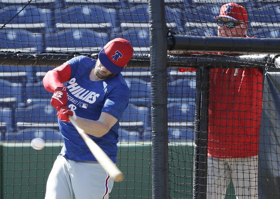 Charlie Manuel watches Bryce Harper take swings at batting practice on Sunday. Manuel and Larry Bowa, both former Phillies managers, are at spring training as instructors.