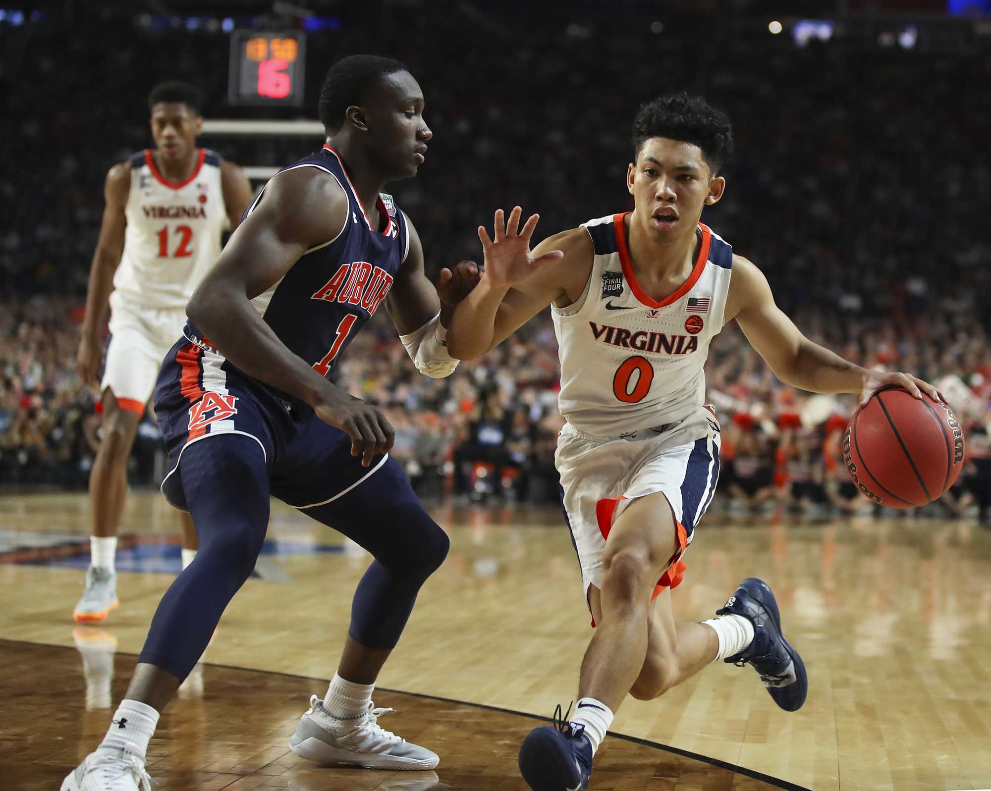 Virginias Kihei Clark (0) drives against Auburns Jared Harper (1) during the second half in a semifinal of the NCAA Tournament Final Four on Saturday, April 6, 2019, at U.S. Bank Stadium in Minneapolis. Virginia advanced, 63-62. (Jerry Holt/Minneapolis Star Tribune/TNS)