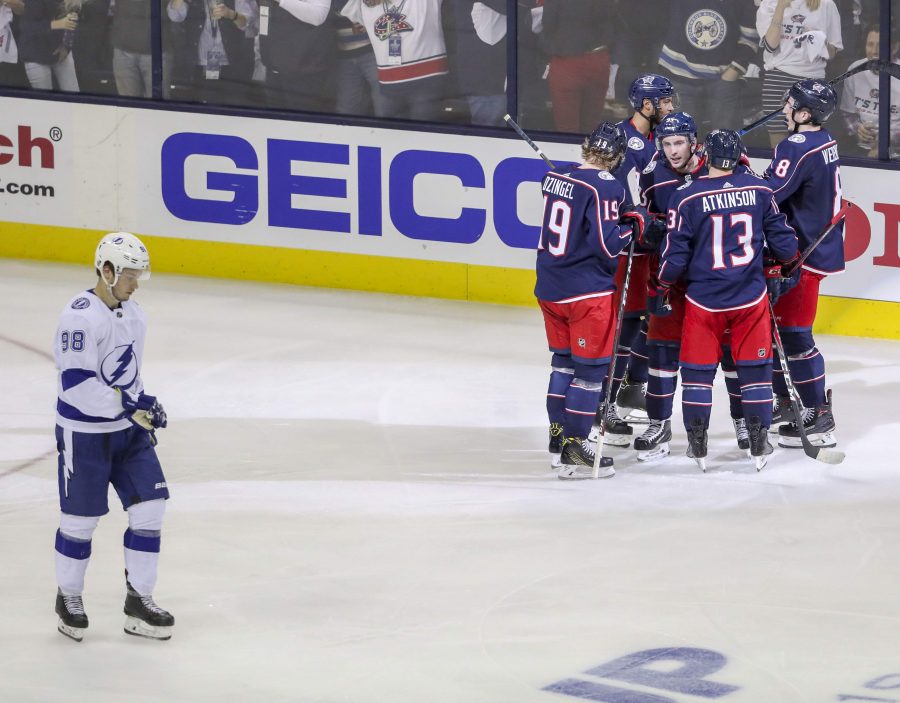 Tampa Bay Lightning defenseman Mikhail Sergachev (98), bottom, skates by as Columbus Blue Jackets teammates celebrate a second period goal by Columbus Blue Jackets defenseman Seth Jones  of Game 4 in the first round of the Stanley Cup Finals Tuesday, April 16, 2019 in Columbus. DIRK SHADD   |   Times