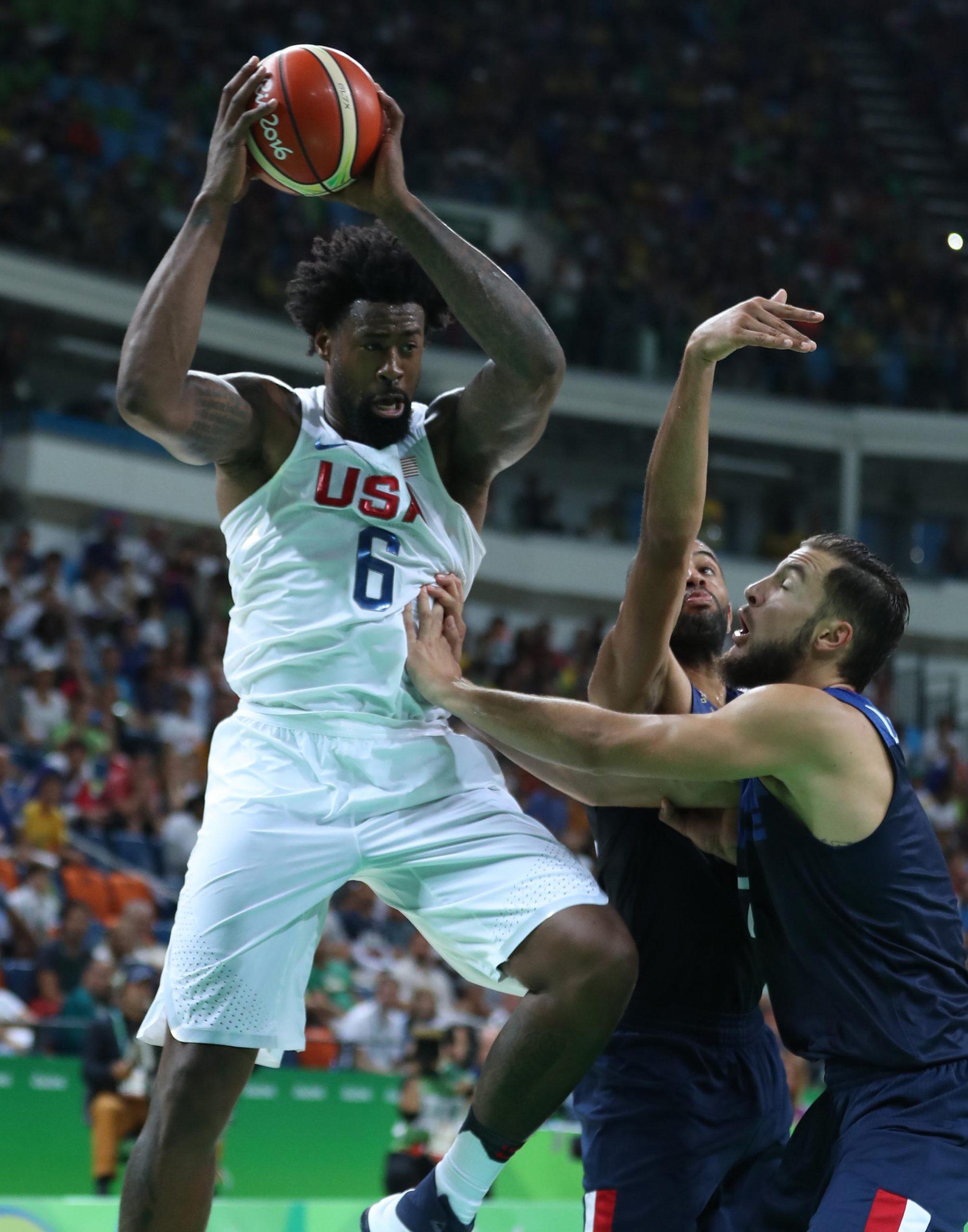 DeAndre Jordan, left, of the U.S. mens basketball team competes during a mens preliminary round match against France on Sunday, Aug. 14, 2016 at the 2016 Rio Olympic Games in Rio de Janeiro, Brazil. The U.S. won 100-97. (Meng Yongmin/Xinhua/Zuma Press/TNS)