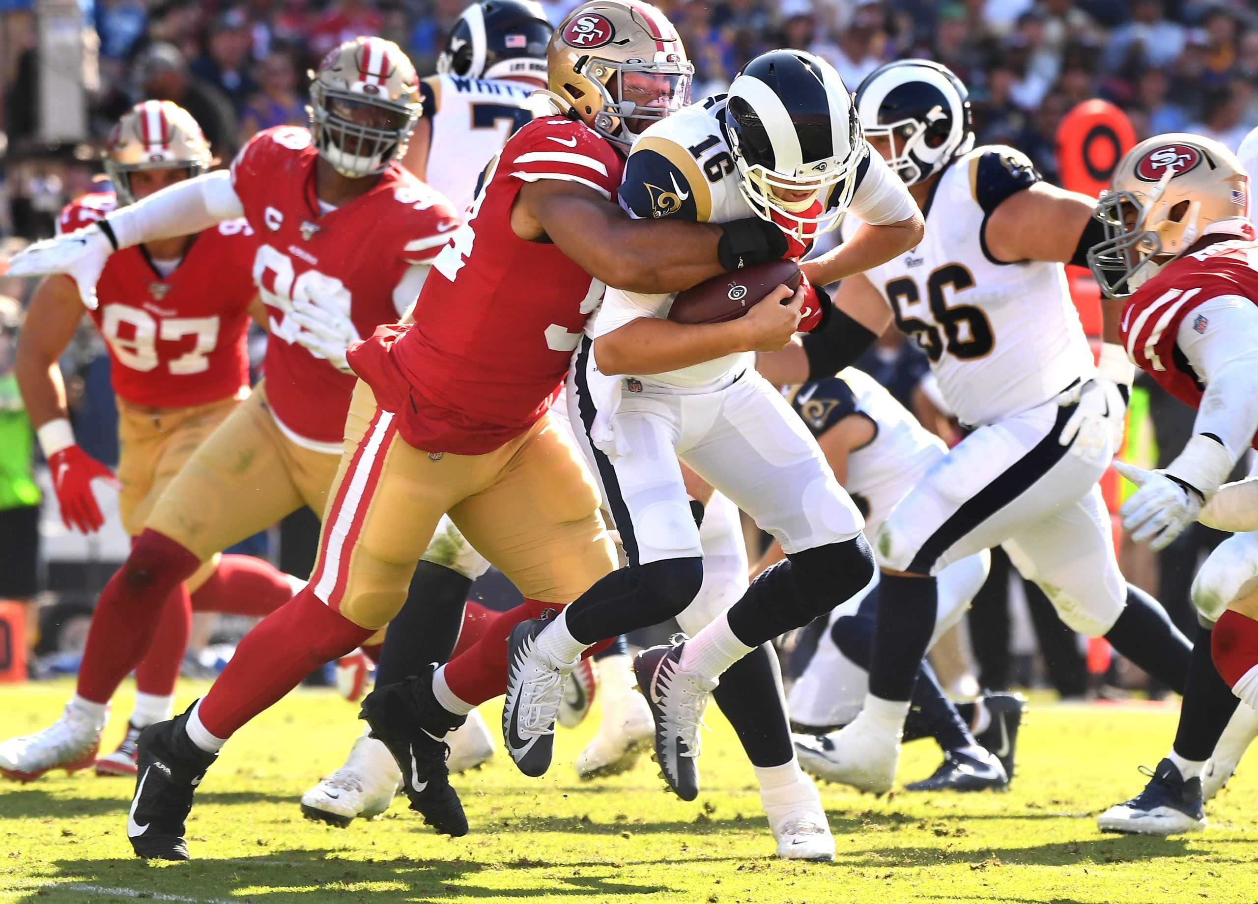 LOS ANGELES, CALIFORNIA OCTOBER 13, 2019-Rams Jared Goff is sacked by 49ers defensive lineman Solomon Thomas in the 3rd quarter at the Coliseum Sunday. (Wally Skalij/Los Angeles Times)