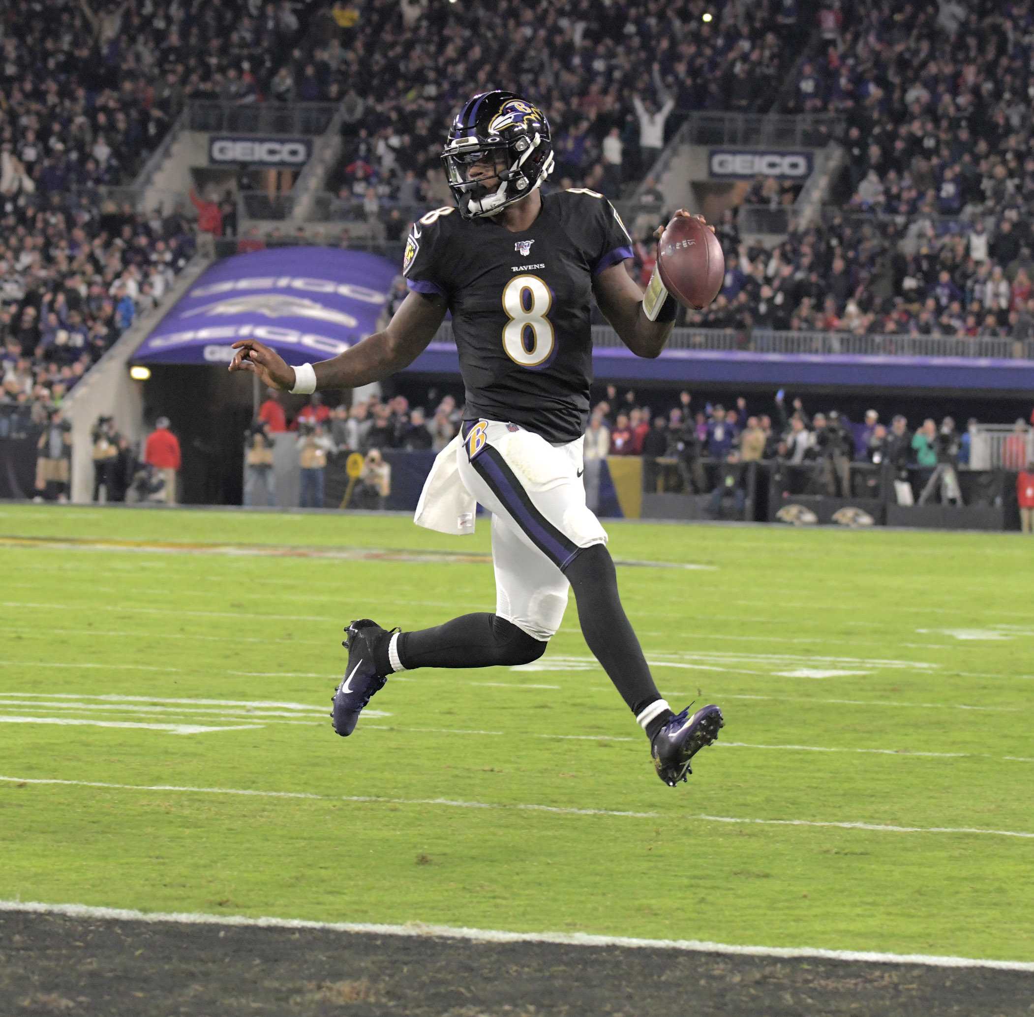 Ravens #8, Lamar Jackson, runs in for a score against the New England Patriots in the first half at M&T Bank Stadium on November 3, 2019.