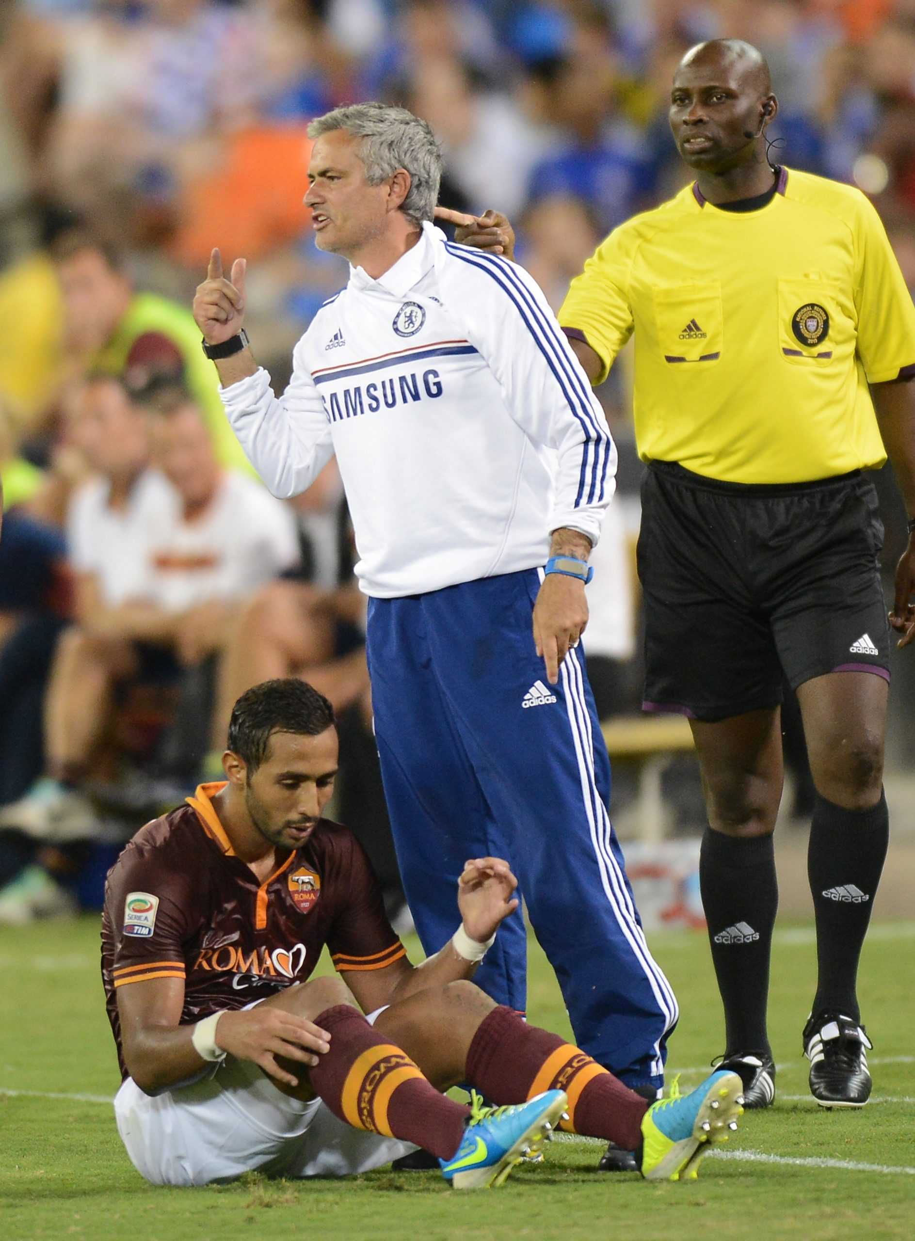 Chelsea FC coach Jose Mourinho signals to his players as AS Roma forward Mehdi Denatia (17) sits on the pitch below him in the second half of an internationals friendly at RFK Stadium in Washington, D.C., Saturday, August 10, 2013. Chelsea defeated Roma 2-1. (Chuck Myers/MCT)