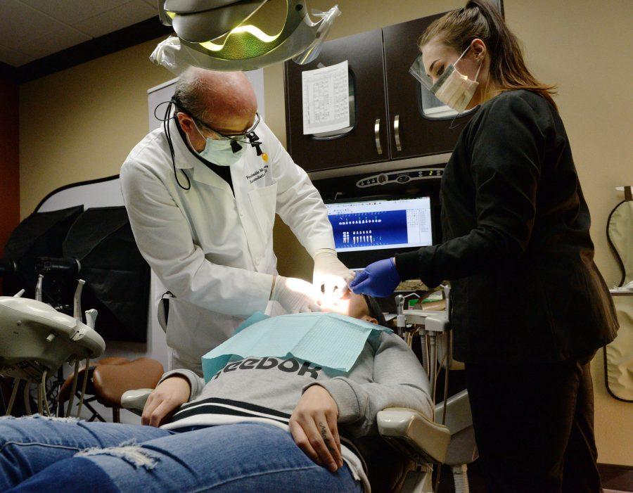 Erlinda Vargas of Fresno receives her new implant-supported permanent dentures from Dr. Sam Namdarian during her last appointment to replace her own missing and decaying teeth at Fresno Smile Makeovers in Fresno on Monday, March 4, 2019. Vargas is the first recipient of the Fresno Oral Maxillofacial Surgery & Dental Implant Centers Second Chance program to help people with extensive tooth loss and other oral health issues but who are unable to afford proper treatment. Vargas suffered through domestic abuse in her family as a child and did not receive proper dental care leading to her oral health issues. (Craig Kohlruss/Fresno Bee/TNS)
