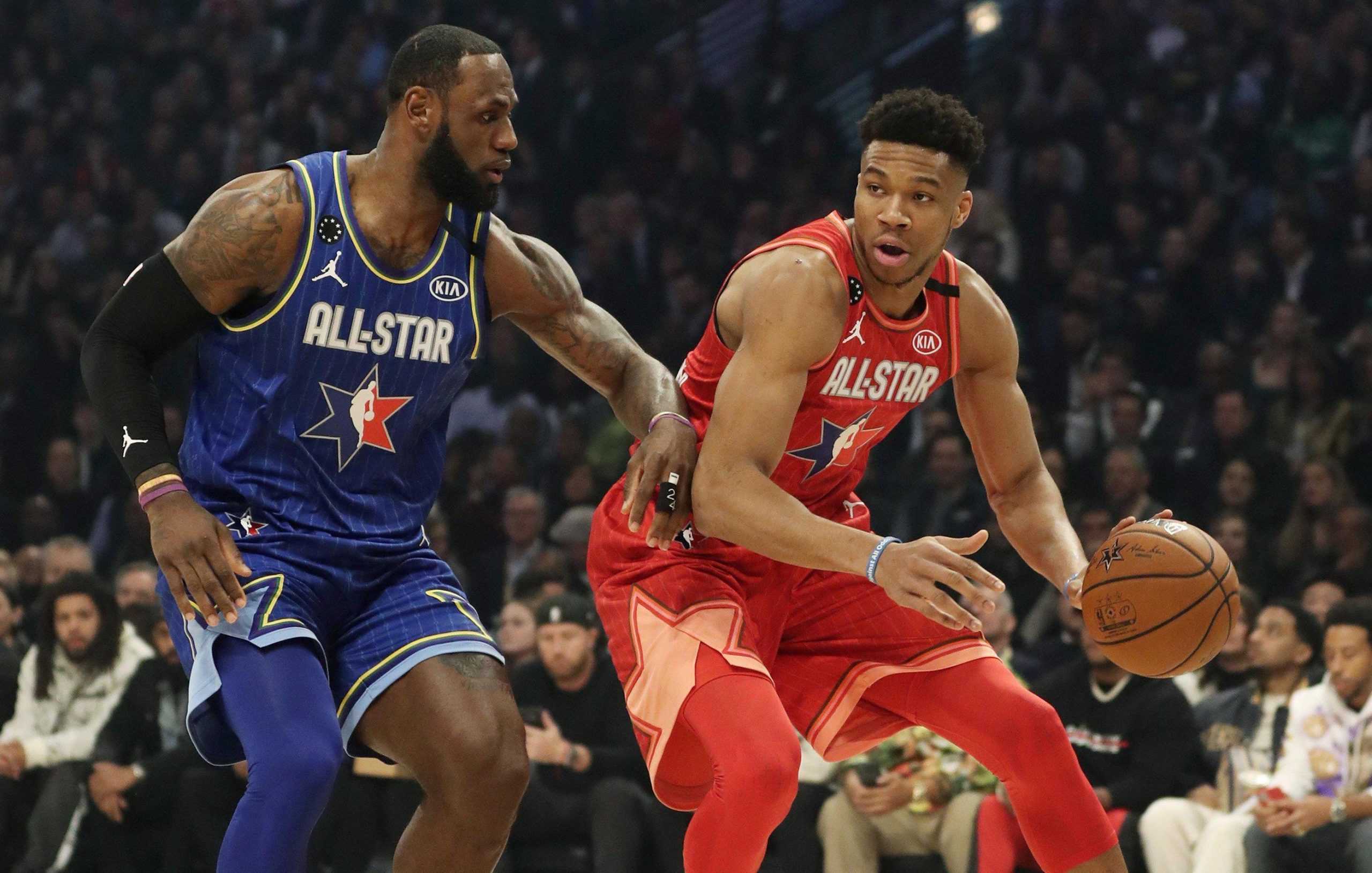 Giannis Antetokounmpo of Team Giannis dribbles past LeBron James of Team LeBron in the first quarter of the NBA All-Star Game on Sunday. [JOHN J. KIM/CHICAGO TRIBUNE]