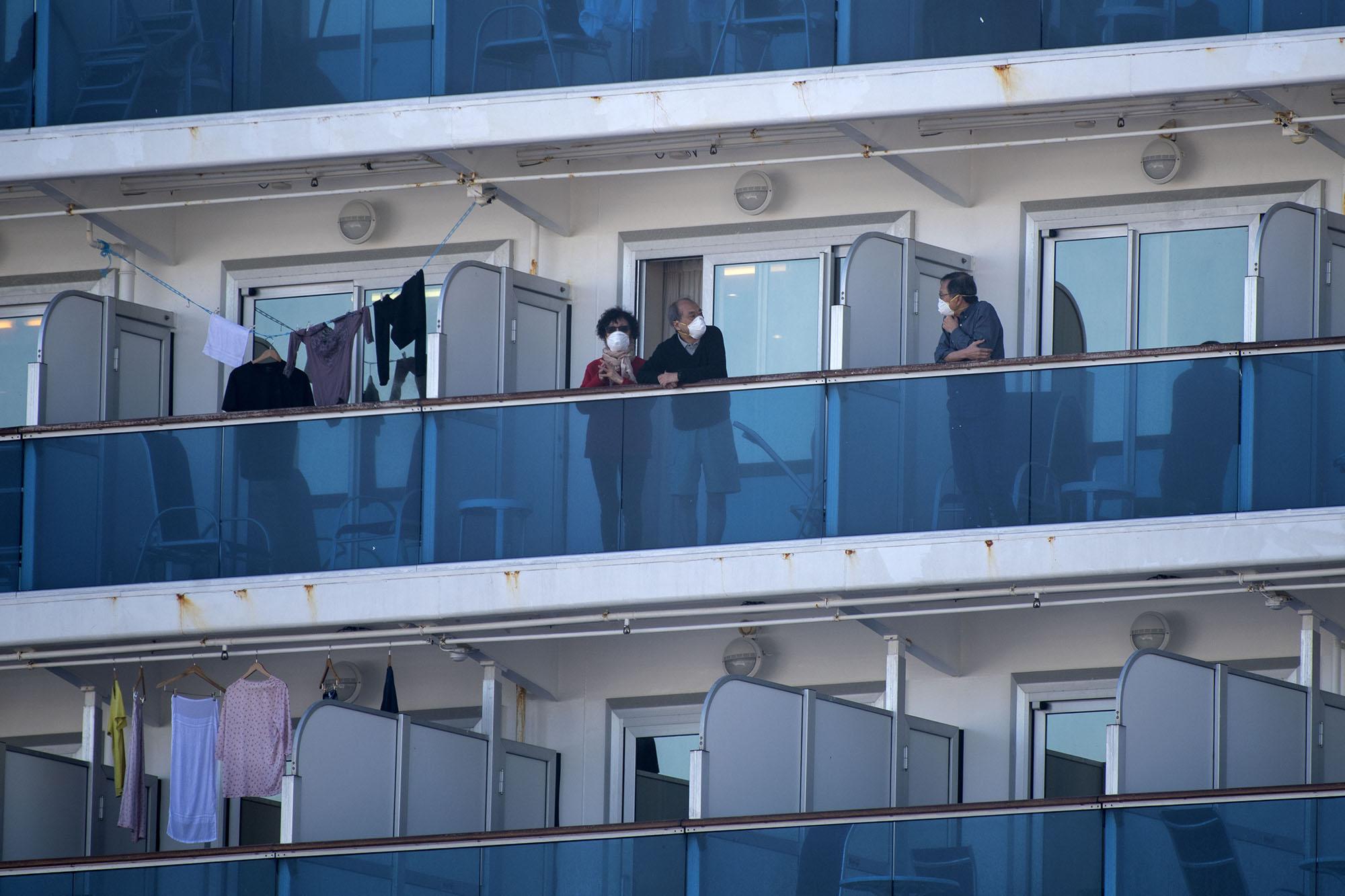Passengers of the Diamond Princess cruise ship stand on their cabins balconies at the Daikoku Pier Cruise Terminal in Yokohama, Japan, on February 13, 2020. (Alessandro Di Ciommo/NurPhoto/Zuma Press/TNS)