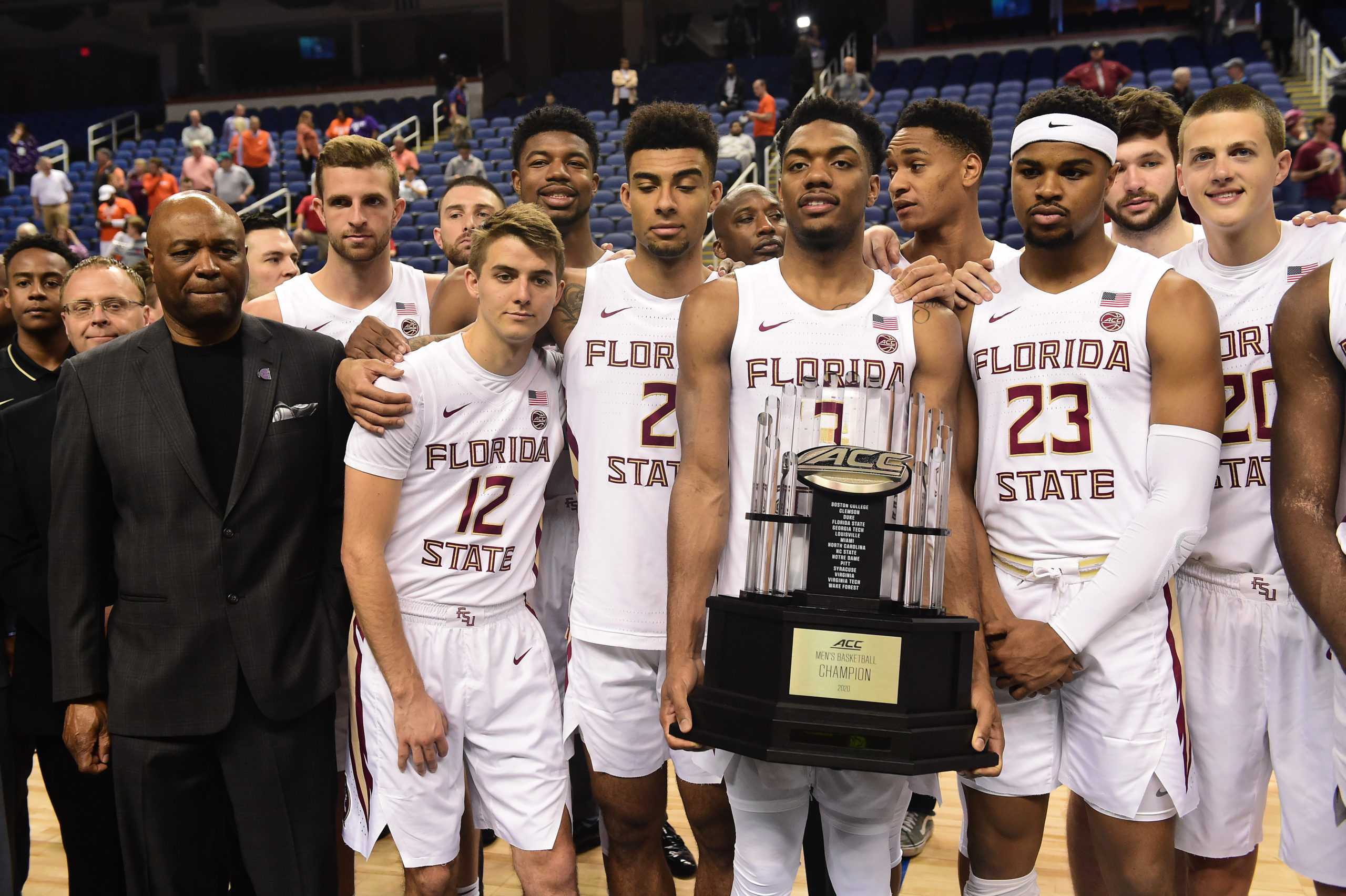 GREENSBORO, NORTH CAROLINA - MARCH 12: The Florida State Seminoles, lead by Head coach Leonard Hamilton (L), are presented with the regular season trophy following the cancelation of the remainder of the 2020 Mens ACC Basketball Tournament at Greensboro Coliseum on March 12, 2020 in Greensboro, North Carolina. The cancelation is due to concerns over the possible spread of the Coronavirus (COVID-19). (Jared C. Tilton/Getty Images/TNS)