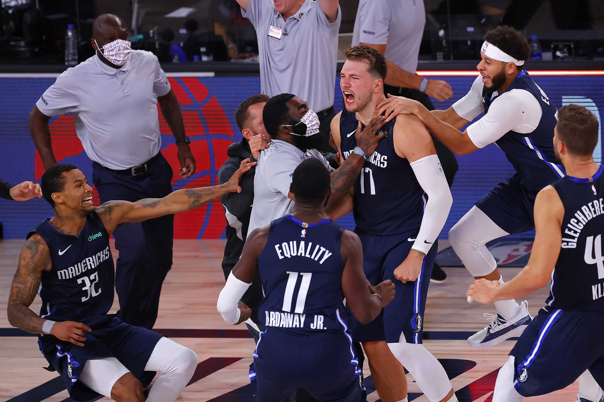 Luka Doncic (77) of the Dallas Mavericks celebrates a game-winning three-point basket with teammates against the Los Angeles Clippers during overtime in game four of the Western Conference First Round on Sunday, August 23, 2020 at AdventHealth Arena at ESPN Wide World Of Sports Complex in Lake Buena Vista, Florida. (Kevin C. Cox/Getty Images/TNS)