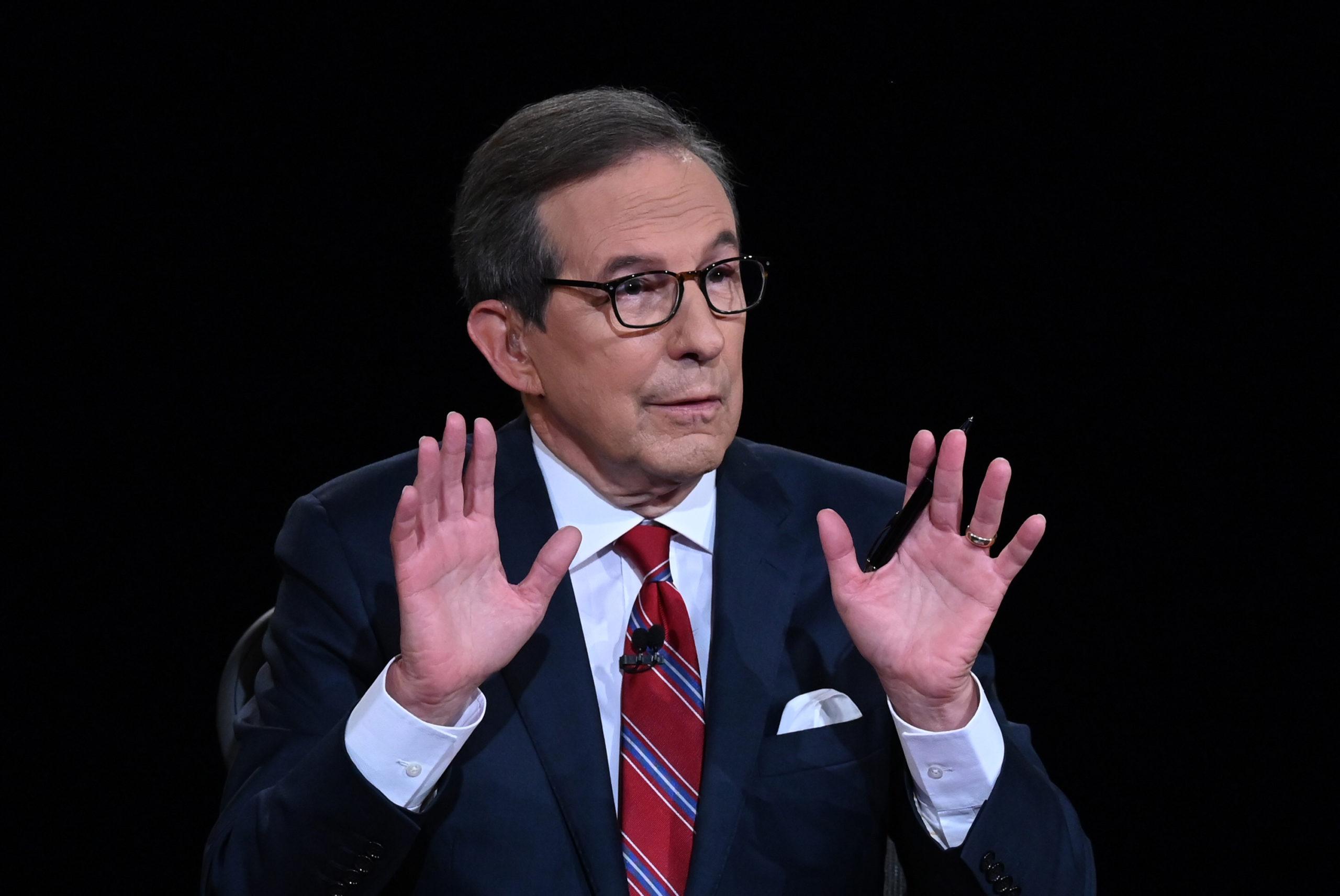Debate moderator and Fox News anchor Chris Wallace directs the first presidential debate between President Donald Trump and Democratic presidential nominee Joe Biden at the Health Education Campus of Case Western Reserve University in Cleveland on September 29, 2020. (Olivier Douliery/Pool/Getty Images/TNS)