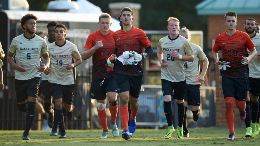 Wake Forest goalie Andrew Pannenberg, who was drafted by Orlando City in this year’s MLS Draft, running with McNally.