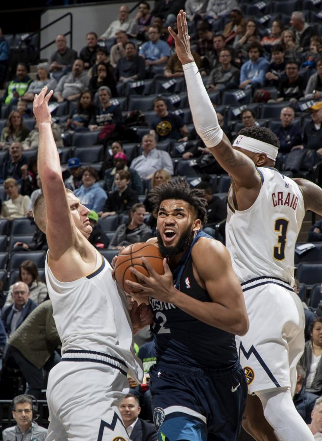 Towns fights through contact for a
shot against the Denver Nuggets.