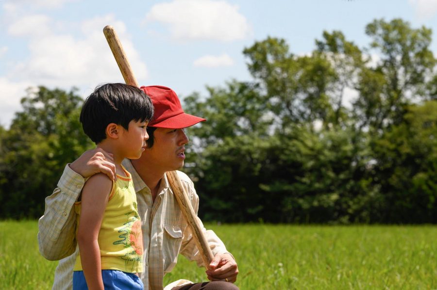 In this scene from Minari, Jacob (Steven Yeun) and his son David (Alan Kim) embrace and look out at their 50-acre farm in an attempt to divine water.