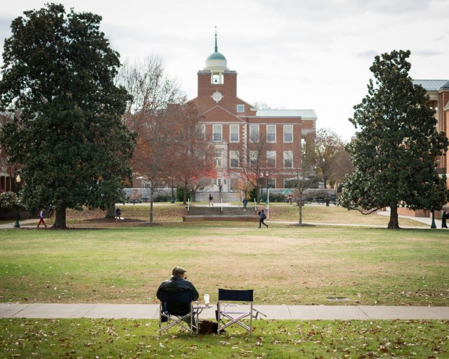 Dr. Hamilton sits in front of Greene Hall overlooking Manchester Plaza while smoking his pipe on an autumn day in 2013. Hamilton passed away from leukemia this past Saturday at the age of 79.  