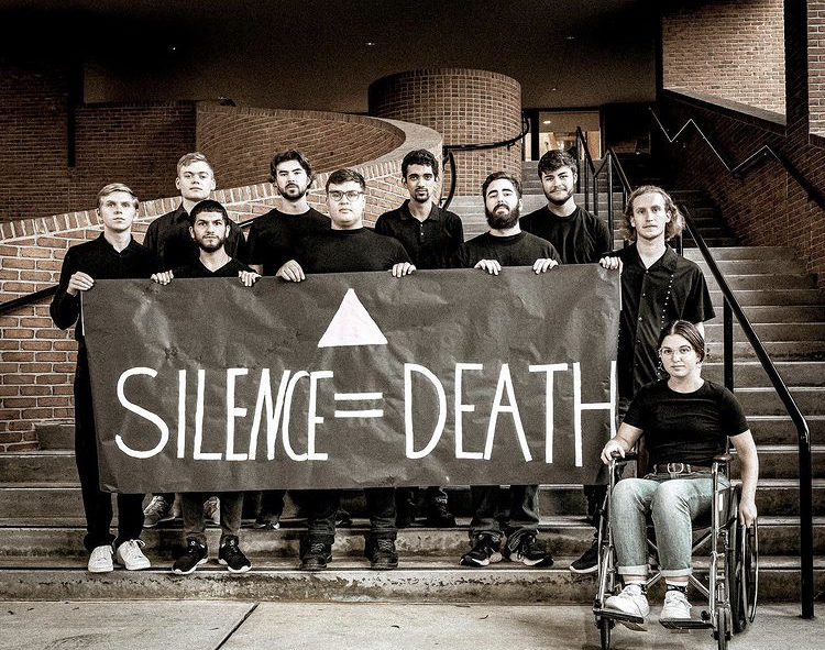 The cast of “The Normal Heart” poses with their “Silence = Death” poster, which now hangs in the Scales Fine Arts Center lobby.