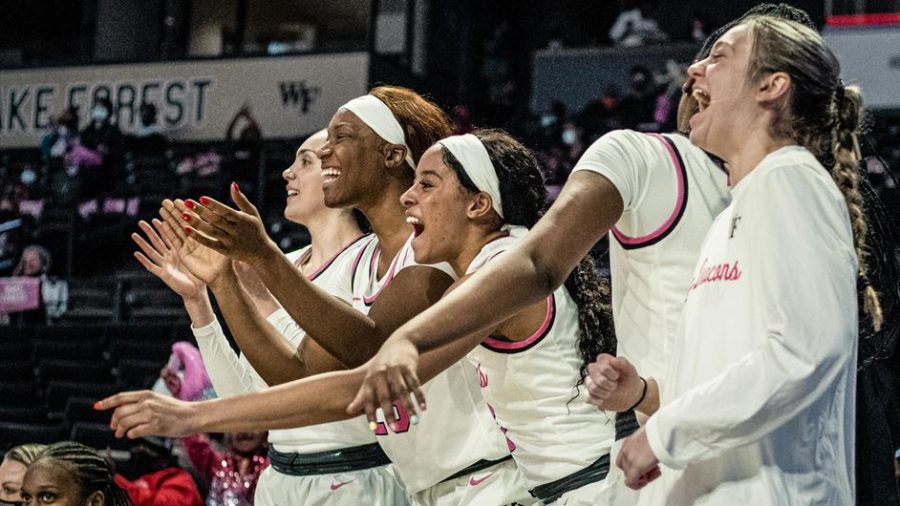 The Demon Deacons celebrate breaking their nine-game losing streak while in their pink “Play4Kay” jerseys. They face off next against N.C. State.