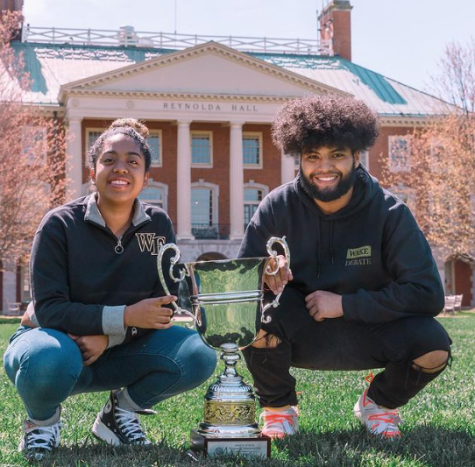 Asya Taylor (left) and Dimarvin Puerto (right) pose with the first place trophy.