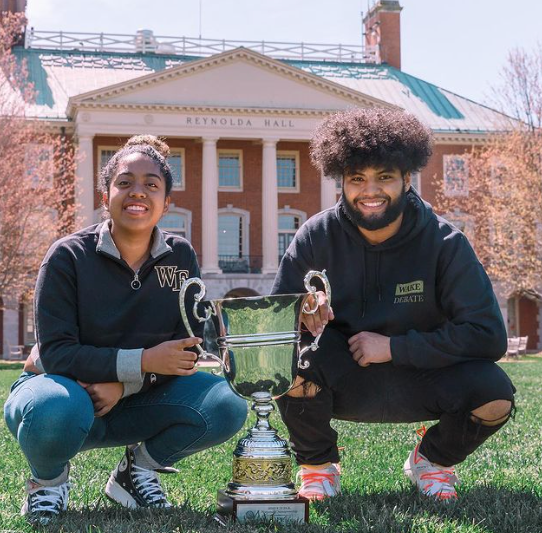 Asya Taylor (left) and Dimarvin Puerto (right) pose with the first place trophy.