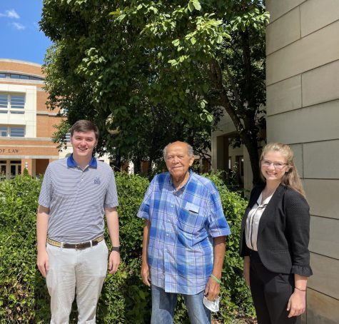 Korean War veteran James Brown (center) stands with his legal team, 2022 WFU Law graduates William Crotty (left) and Ashley Willard (right).