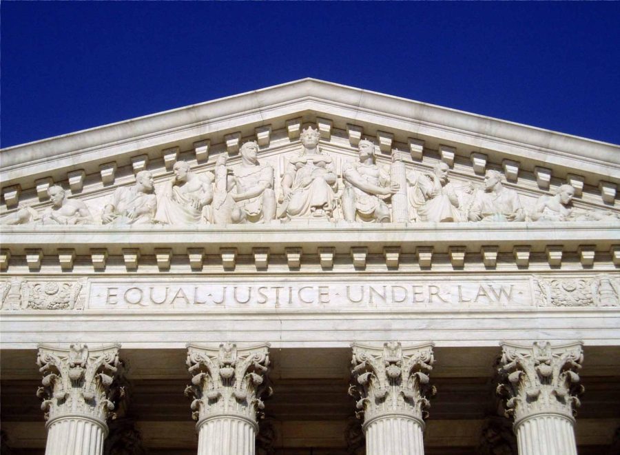 An image of the west facade of the Supreme Court building, which reads equal justice under law.