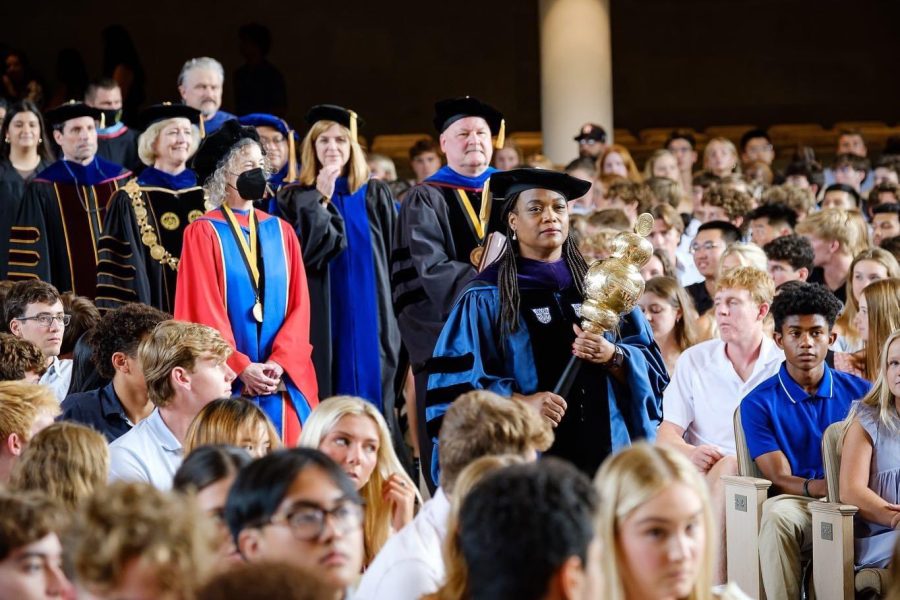 A+photograph+of+the+Wake+Forest+faculty+processing+down+the+center+aisle+of+Wait+Chapel+while+members+of+the+Class+of+2026+look+on.
