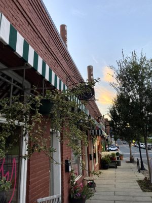 A photo of the sunset and a brick building in Winston-Salem.