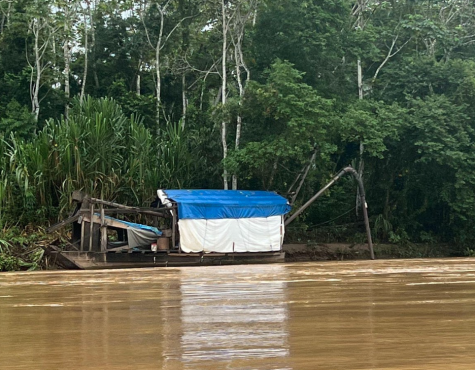 A photograph of gold mining equipment along the Amazon River.