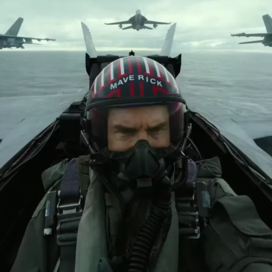 A still from Top Gun Maverick showing a fighter pilot during a battle over the water