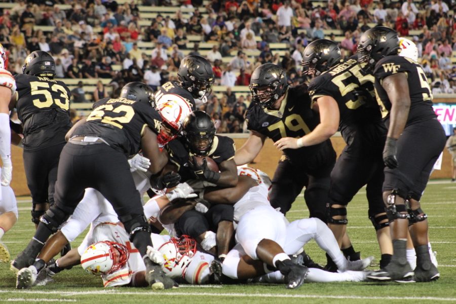 A photograph of the end of a rushing play in football.