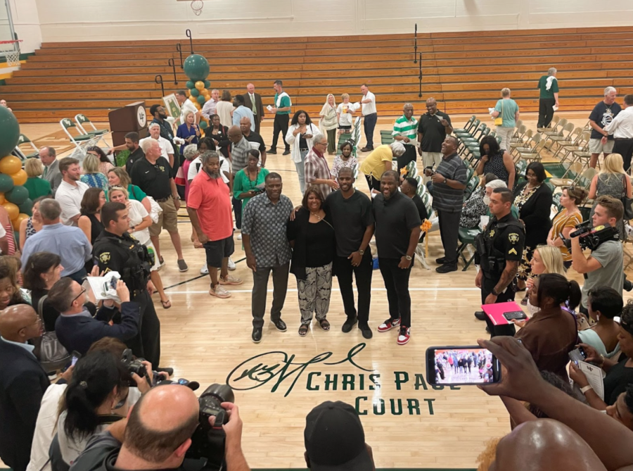 A photograph of a gathering on West Forsyth High School's basketball court