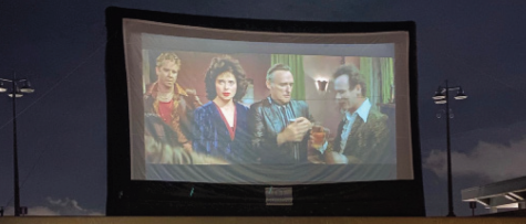 A photograph of a movie playing on a drive-thru theatre screen.