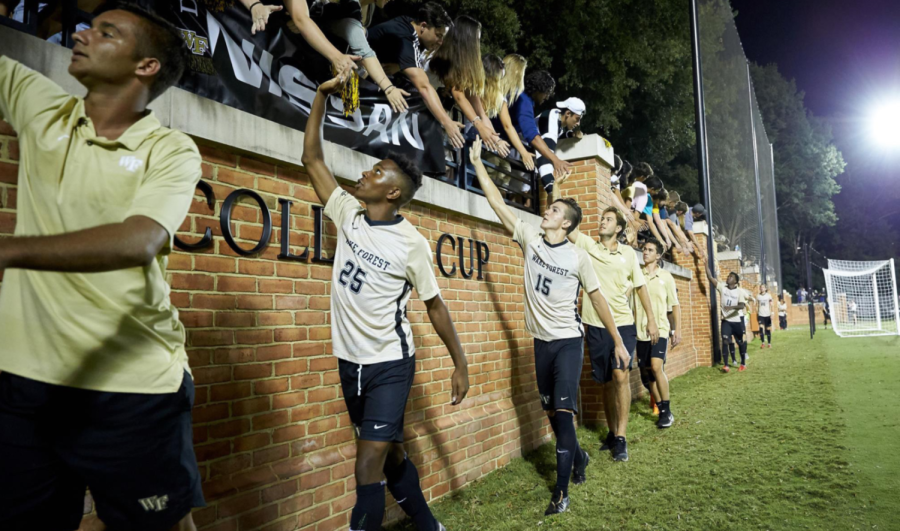 The Wake Forest Mens Soccer Team high-five the Spry crowd after a home victory. The Demon Deacons have been ranked top five nationally in attendance each year since 2015
