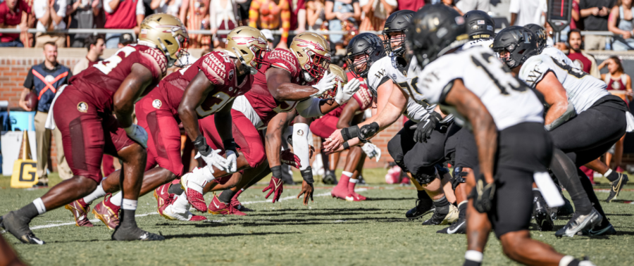 KeShawn Williams (No. 13 in white) prepares to explode off of the line as the Wake Forest offense takes flight.