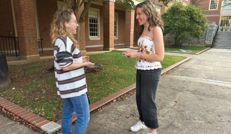 Junior Leanna Bernish asks a student to share the music she is currently listening in an effort to break social norms while outside Tribble Hall.