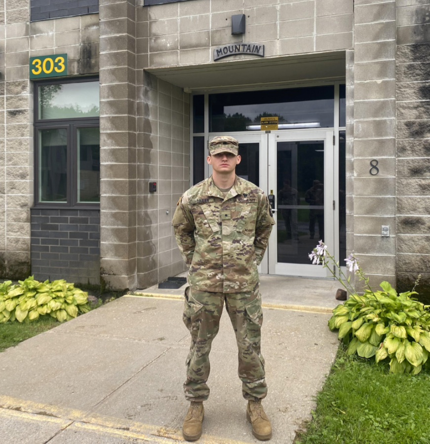 Matthew Dailey (25) stands in front of the Army Mountain Warfare School.