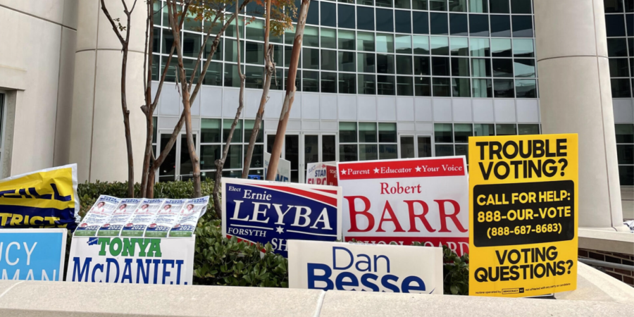 Various signs promoting candidates running for local office are placed outside the Forsyth  
County Government Center, which served as an early voting site in downtown Winston-Salem.  