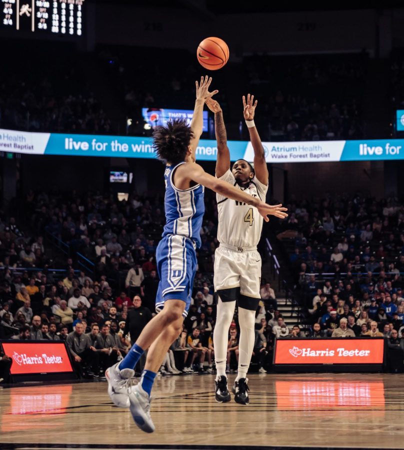 Davien Williamson (no. 4 in white) takes a shot in a home win against Duke.