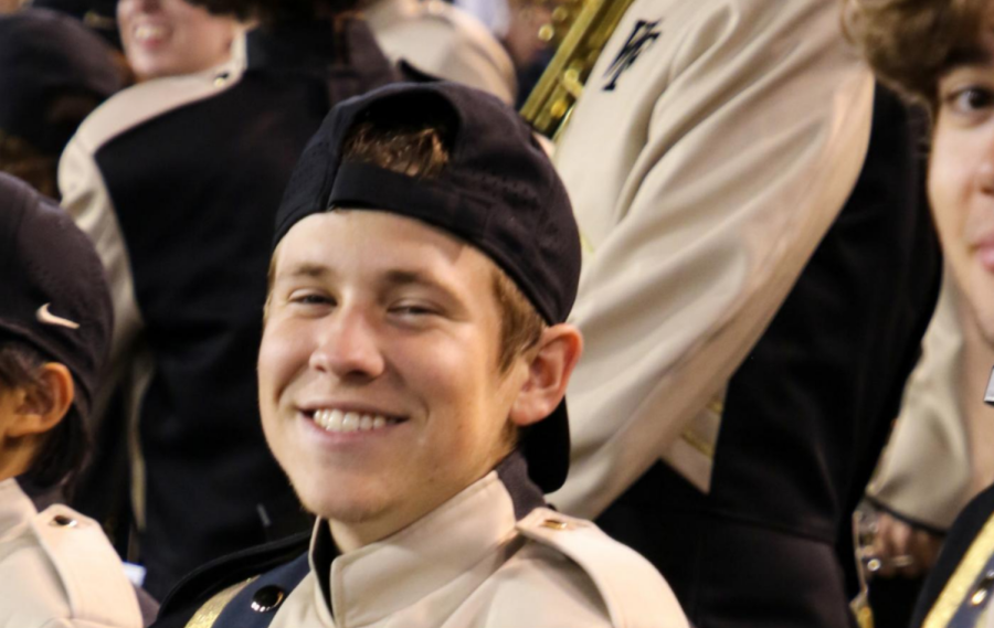 Finnegan Siemion smiles while performing at a football game with the Spirit of the Old Gold & Black.