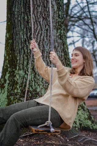 Gretchen Castelloe uses one of the tree swings on campus.