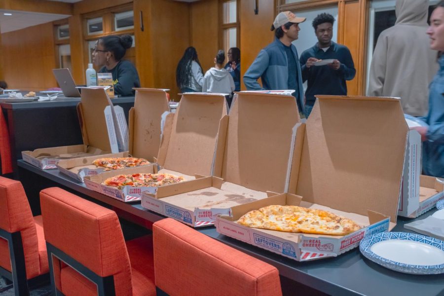 Students converse and eat pizza during Culturalitys Black History Month event.