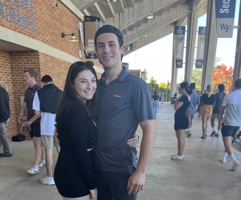 Sophomores Stephanie Glaser and Matthew Trosino, who helped bring Marriage Pact to Wake Forest, pose at a football game.