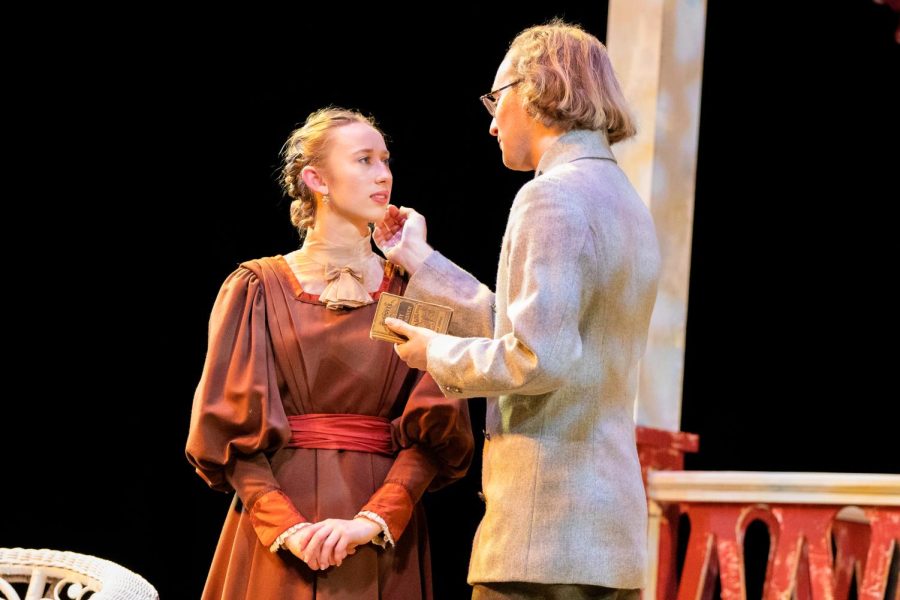 Characters played by senior Sophie Thomas (left) and junior Evan Souza (right) share a tender moment in The Three Sisters.