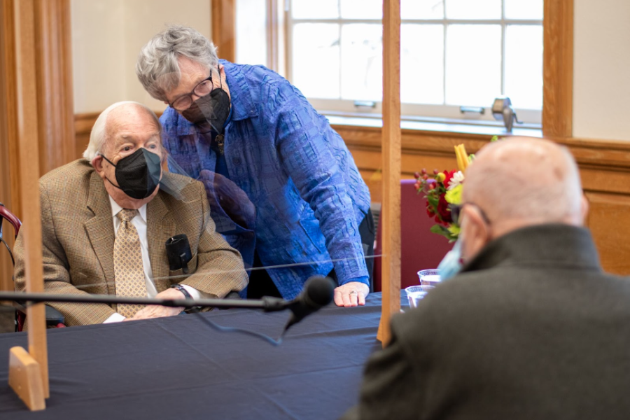 Alumnus Gerald Taylor (front) lowers his mask to show Provost Emeritus Ed Wilson his face at a Feb. 3 event.