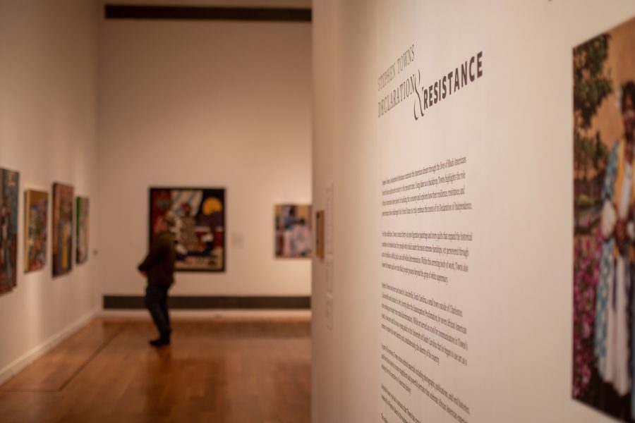 Wall panels provide visitors with information about the exhibit as they examine the artwork.