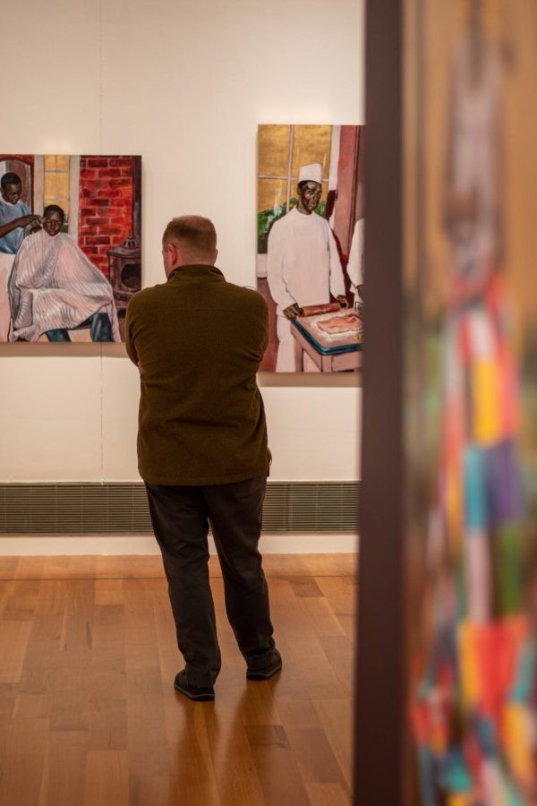 A visitor views Steven Towns paintings.
